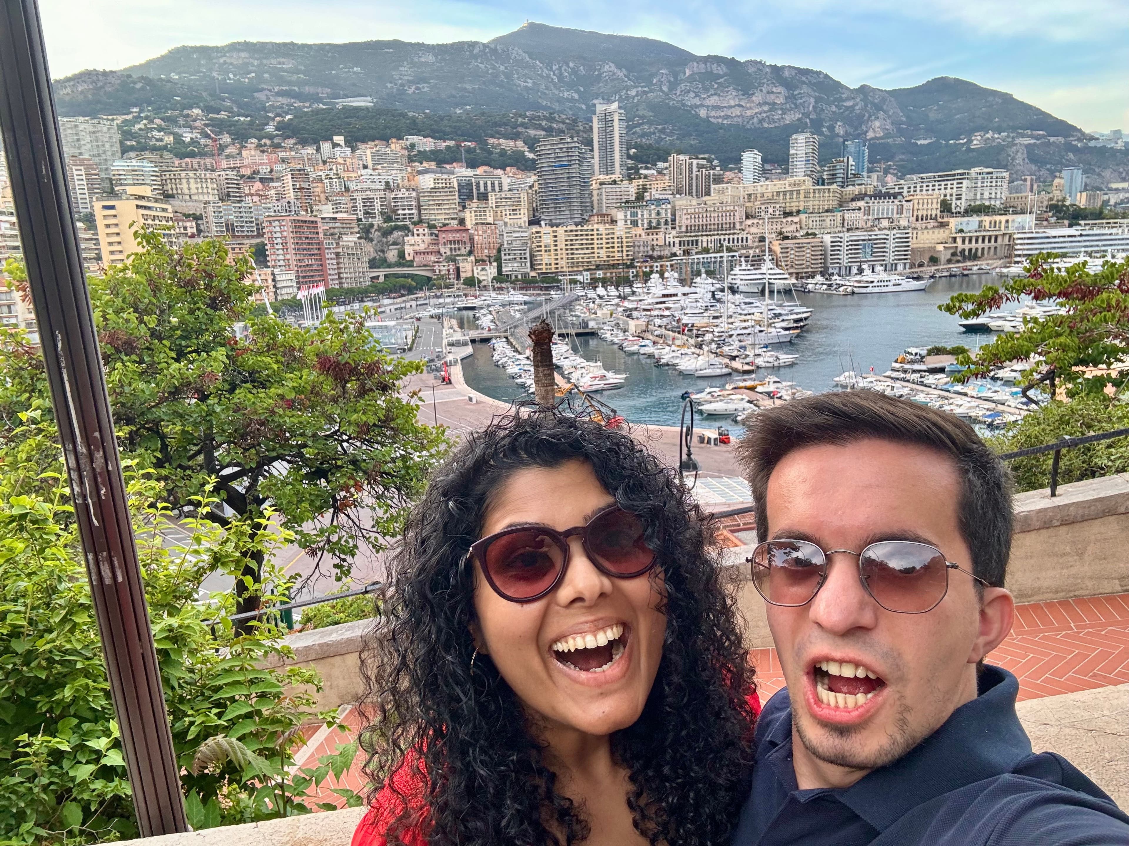 Gayatri and Oleg making excited faces above the harbor in Monaco